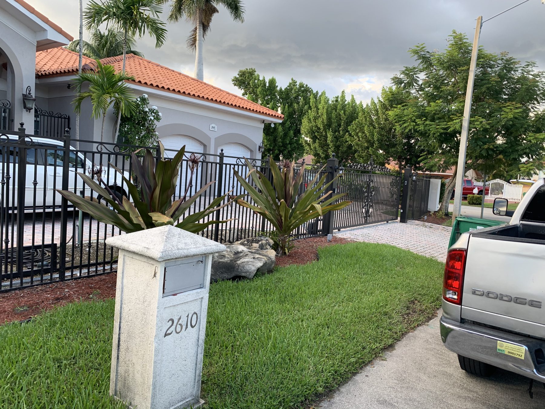 Gated community entrance with lawn and planting