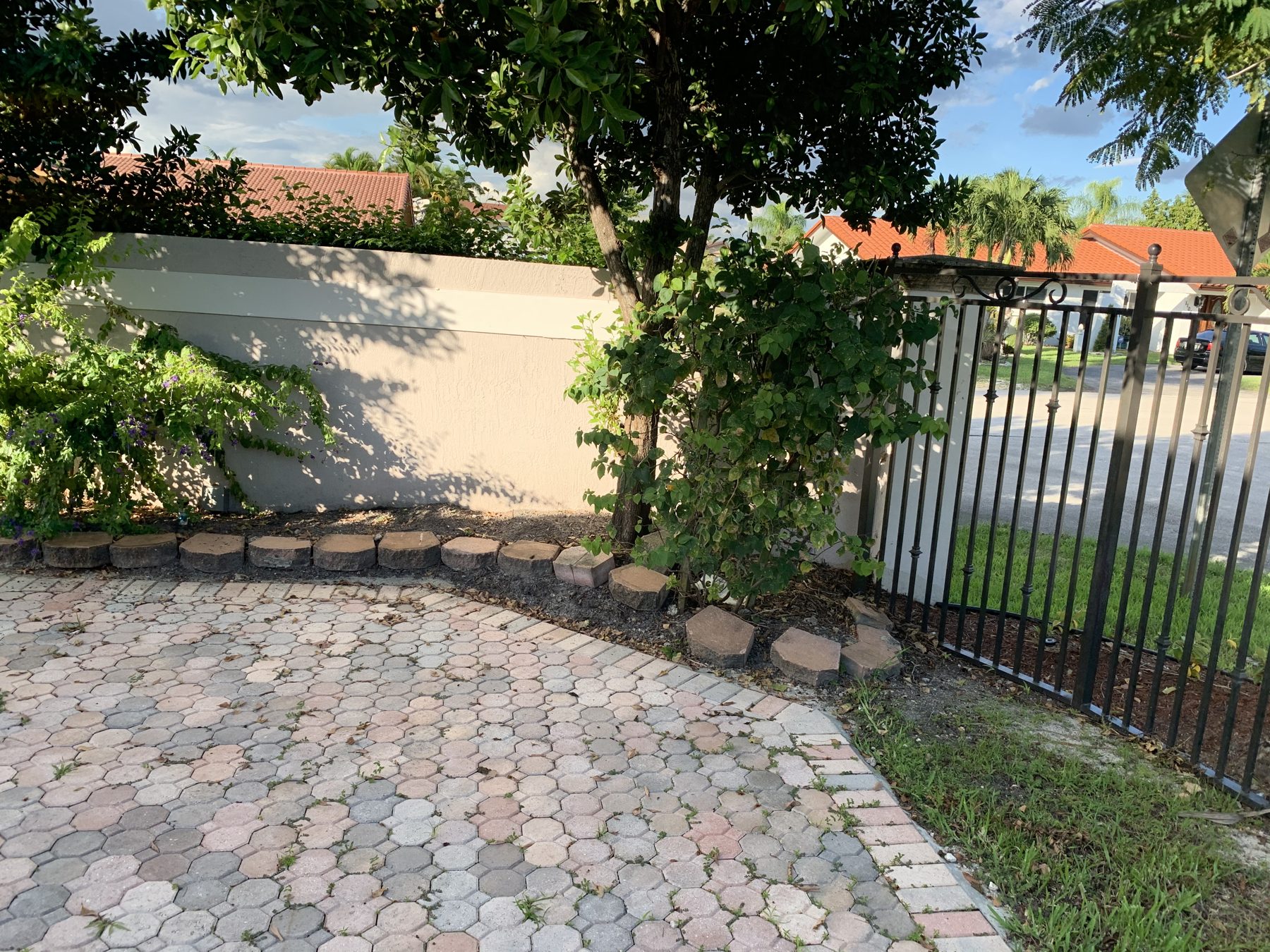 Gated entry with paver drive and hedge